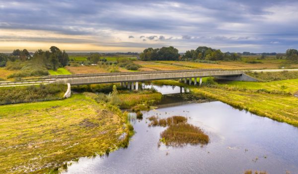 River bridge with wildlife underpass for otters and other aquatic wildlife in national park Weerribben Wieden marshland swamp, Overijssel, Netherlands.